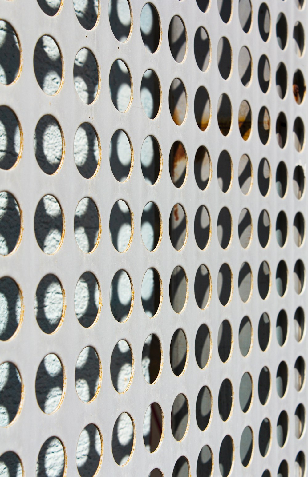 a close up of a metal grate with holes