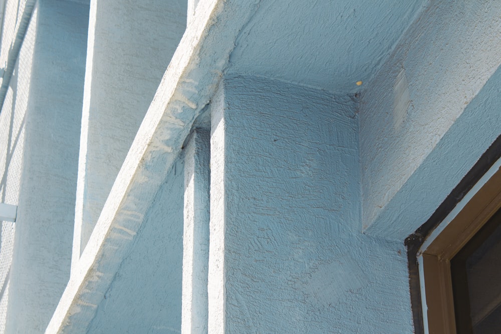 a close up of a blue building with a brown door