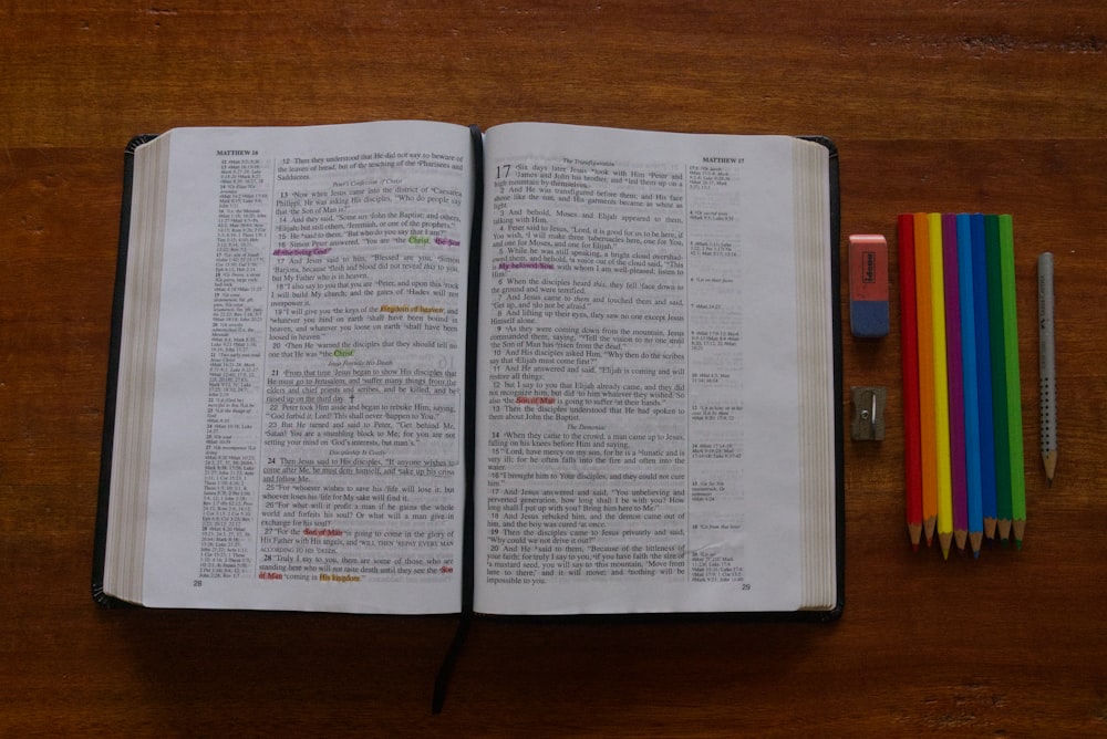 an open book sitting on top of a wooden table