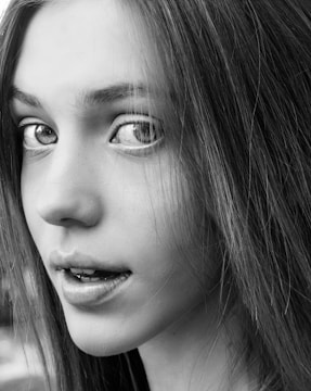 A crisp, black-and-white portrait capturing the raw emotion of a young woman.