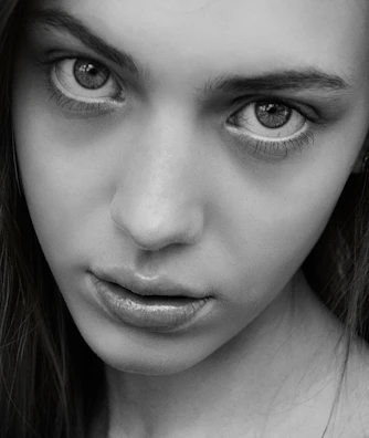 Monochrome frame capturing intense eye contact from a subject mid-rant.