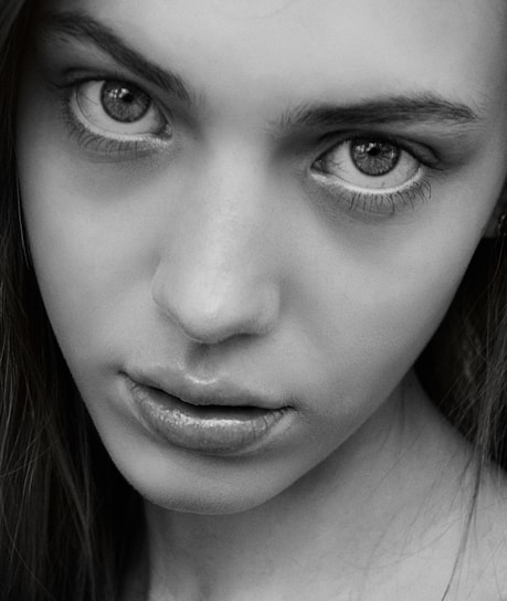 Black and white minimalist portrait of Guadalupe Carlota, showcasing a calm and focused expression.