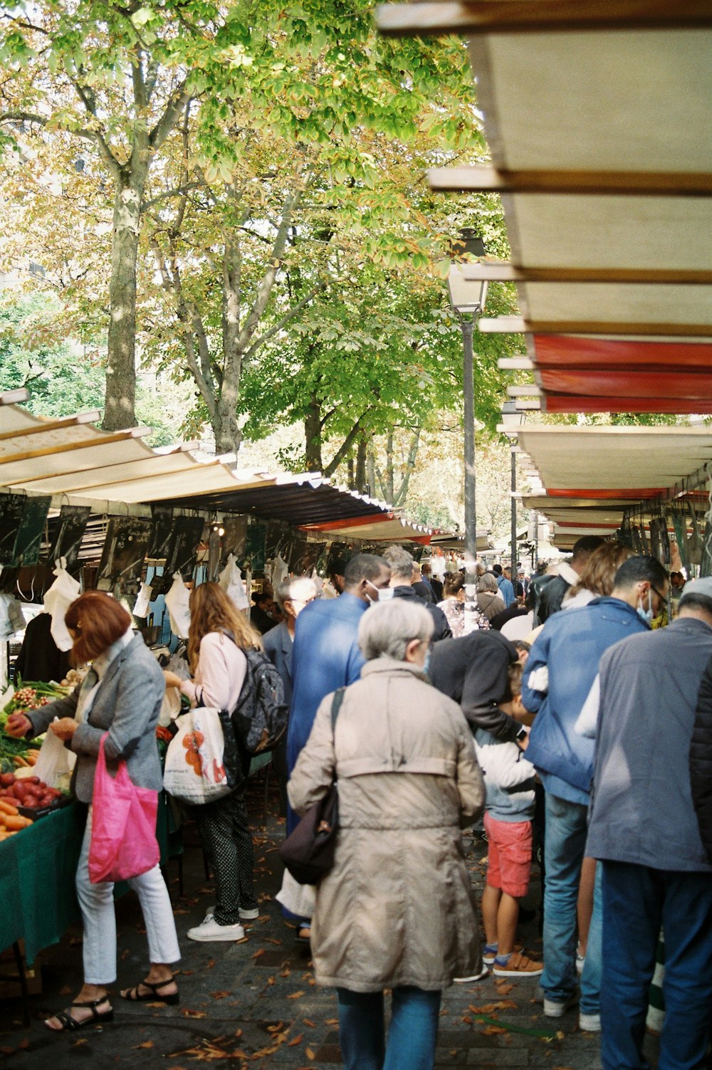 a group of people standing around a market