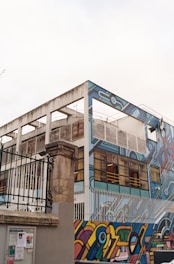 Wide shot of a historic stone facade in Bilbao being cleaned of graffiti using advanced laser equipment.