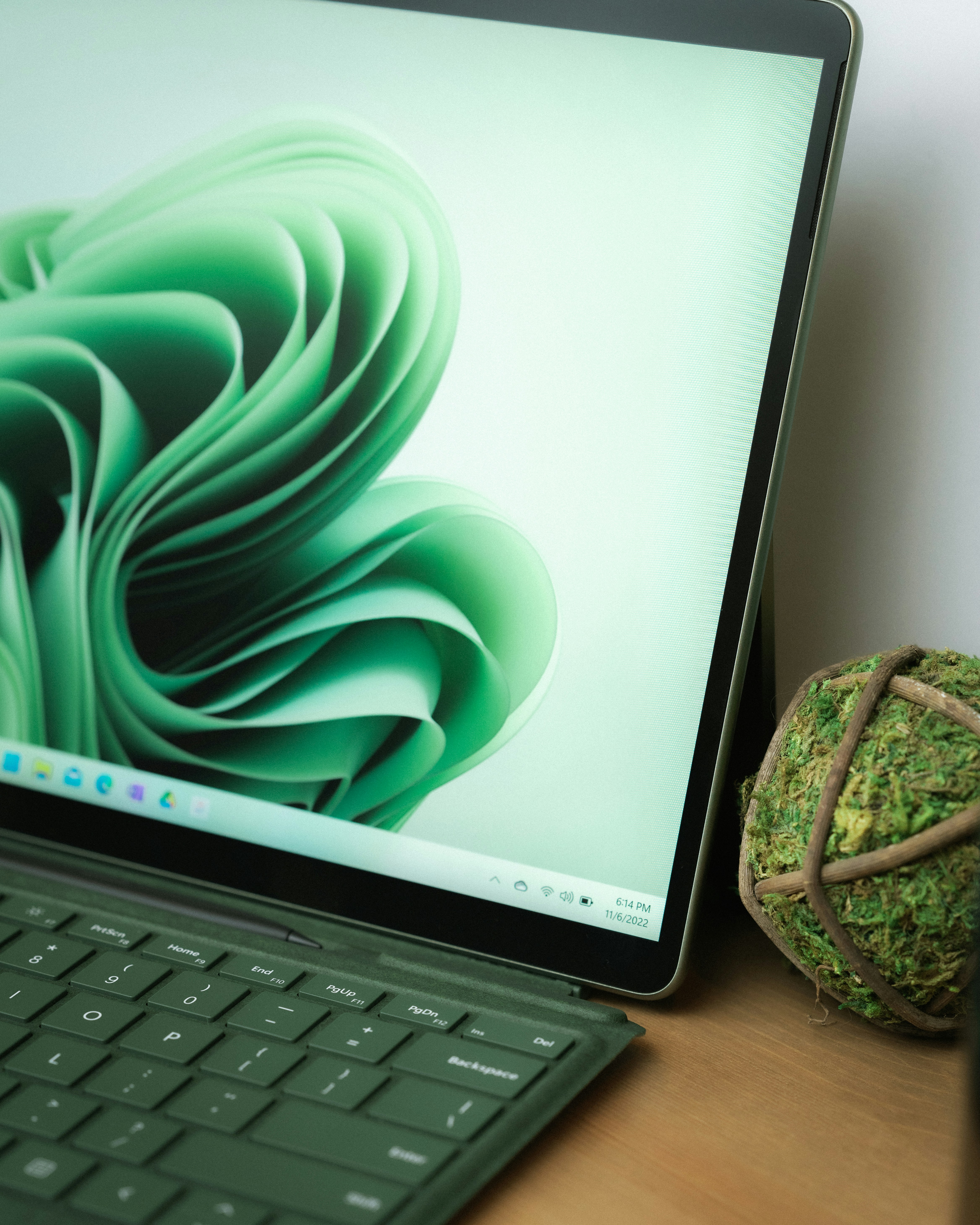 a laptop computer sitting on top of a wooden desk