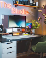 a desk with a computer monitor and a keyboard