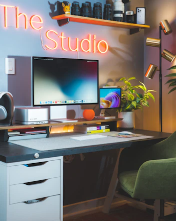 a desk with a computer monitor and a keyboard