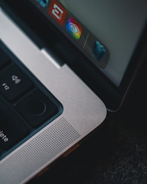 Close-up of hands on a laptop keyboard with a screen showing deleted emails and files.