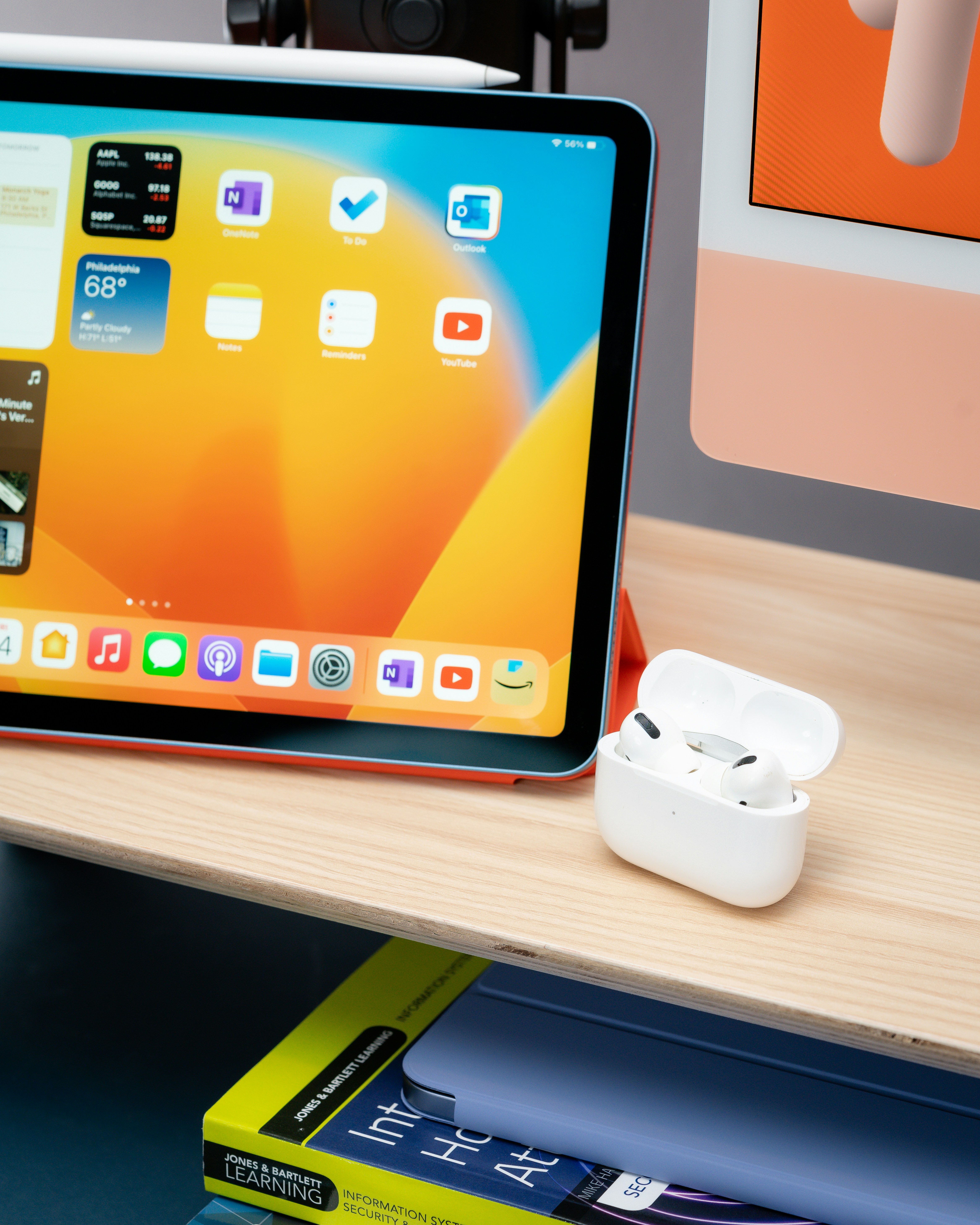 an ipad is sitting on a table next to a book