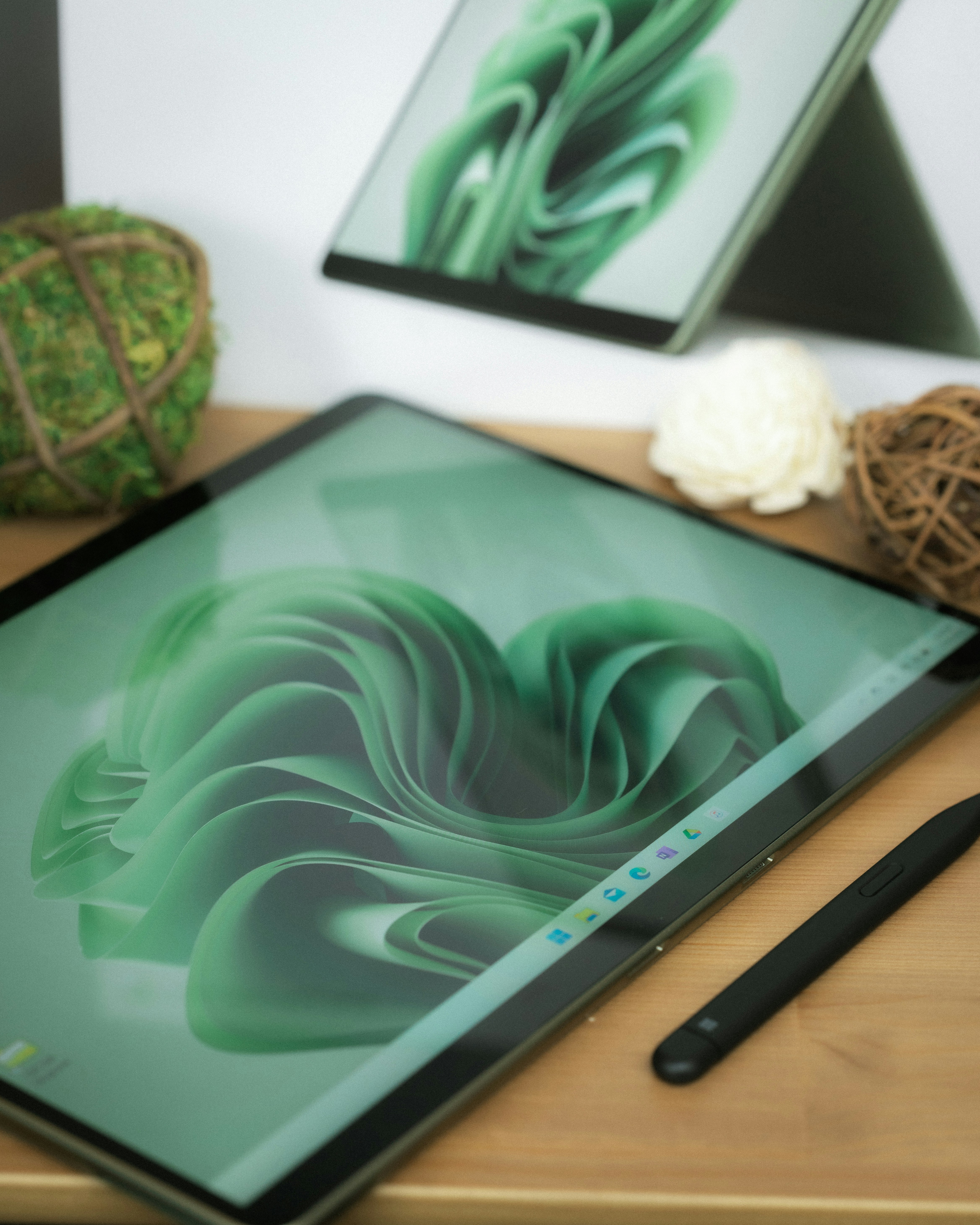 a tablet computer sitting on top of a wooden desk