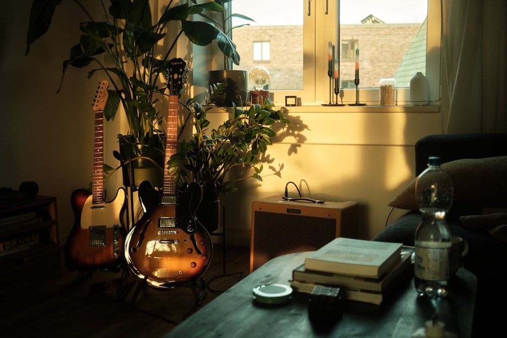 a living room with a guitar and a plant