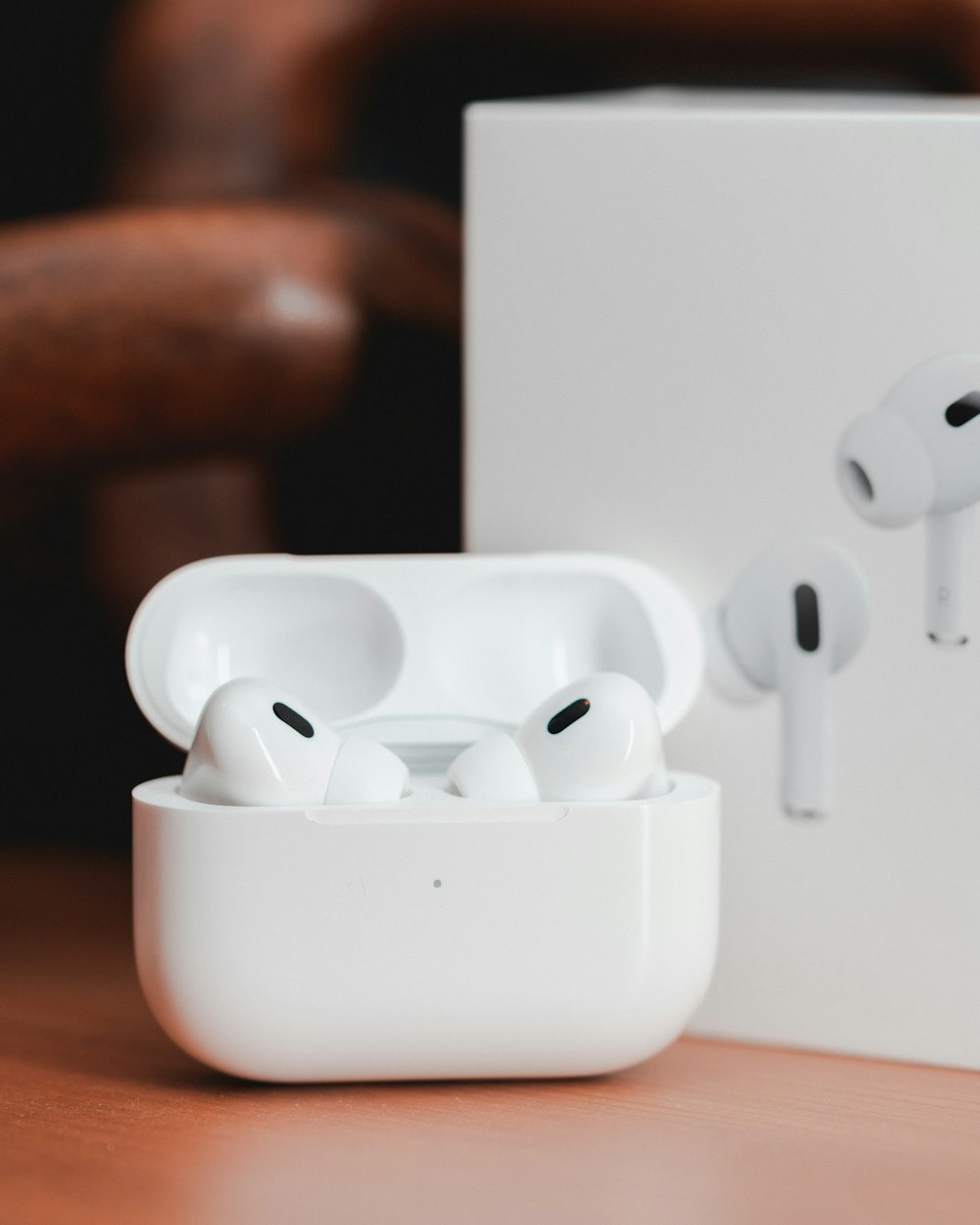 a pair of white earphones sitting on top of a table