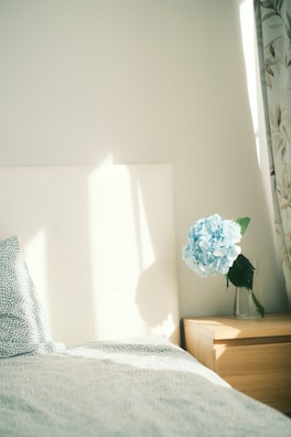 A serene bedroom with a perfectly made bed and organized nightstand.