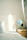 A peaceful bedroom scene with soft purple hues and a lavender-scented automatic spray dispenser on the nightstand.