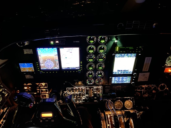 High-resolution image of a realistic cockpit with deep blue and bright orange lighting accents.