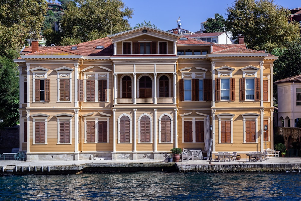 a large yellow building sitting next to a body of water