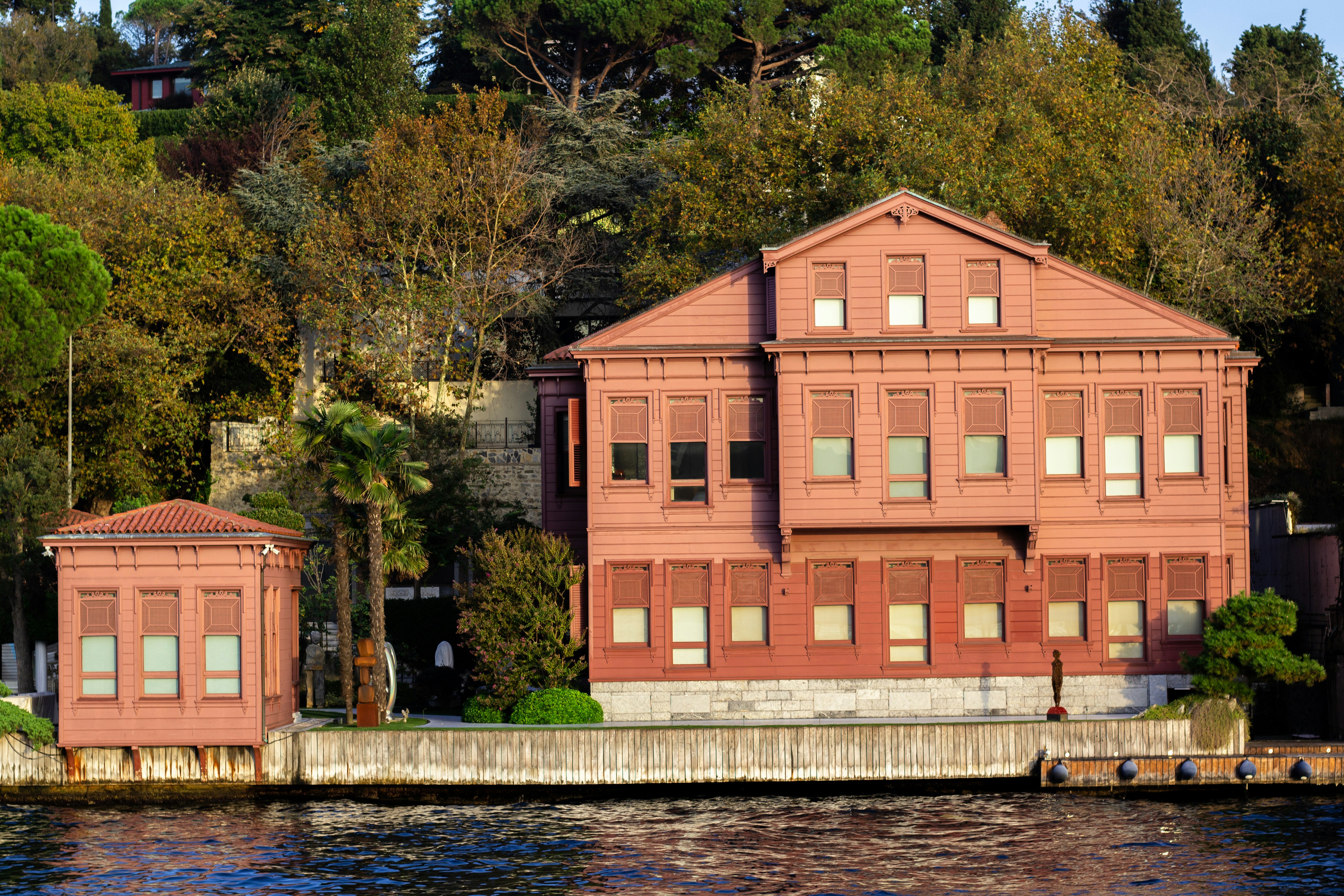 a red building sitting next to a body of water