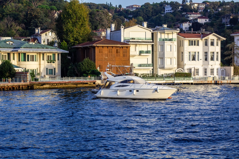 a boat in the water near a row of houses