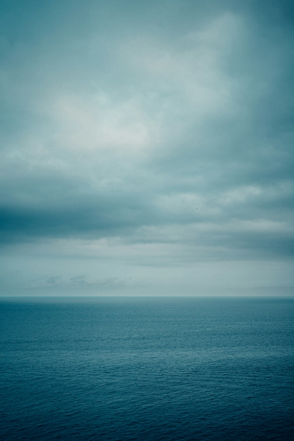 a large body of water under a cloudy sky