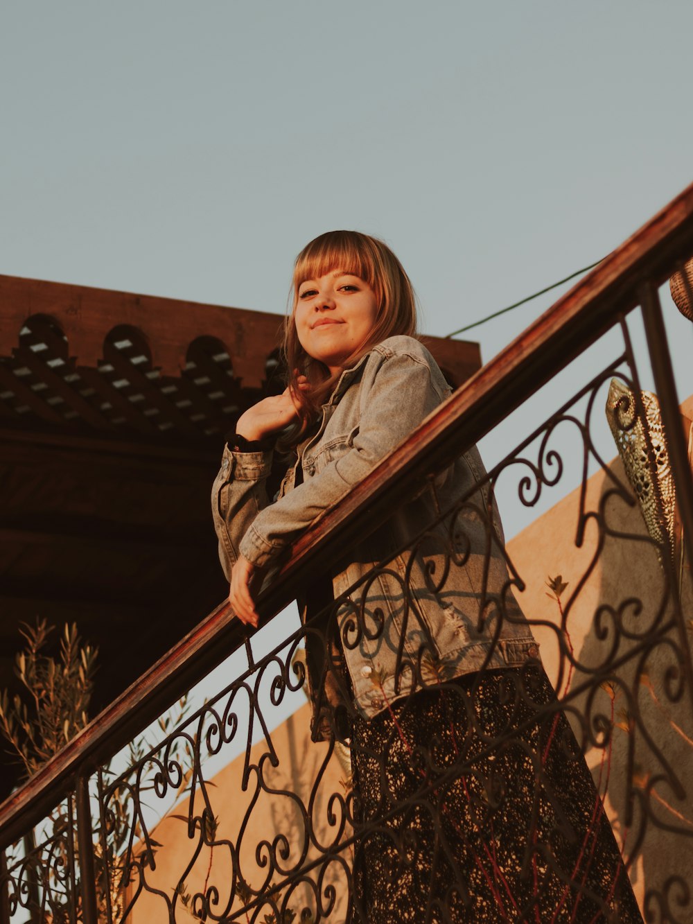 a little girl is standing on a balcony