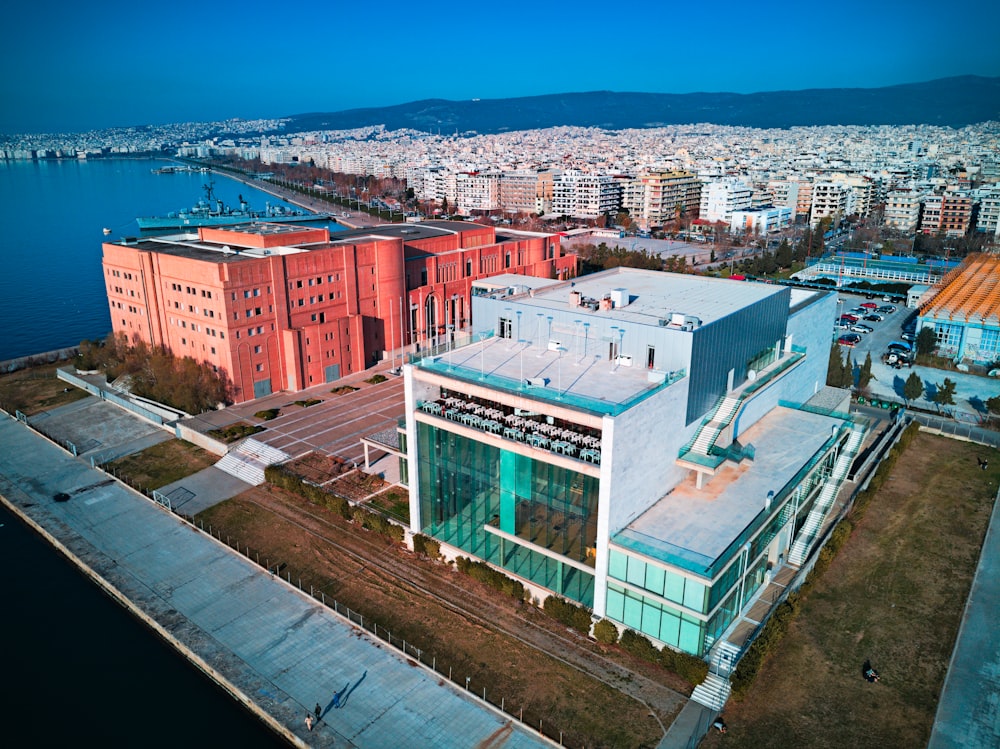 an aerial view of a large building next to a body of water