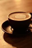 Rotating animation of the coffee of the day in a warm, inviting setting.