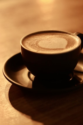 Softly lit scene of a woman enjoying coffee in a serene Parisian apartment, surrounded by minimalist art and elegant decor.
