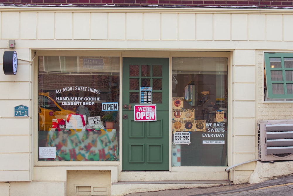 a store front with a green door and window