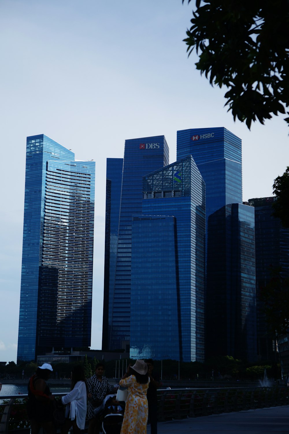 a group of people standing in front of tall buildings