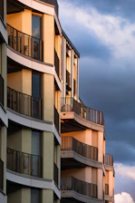 Modern apartment buildings in a vibrant Mexican cityscape during sunset.