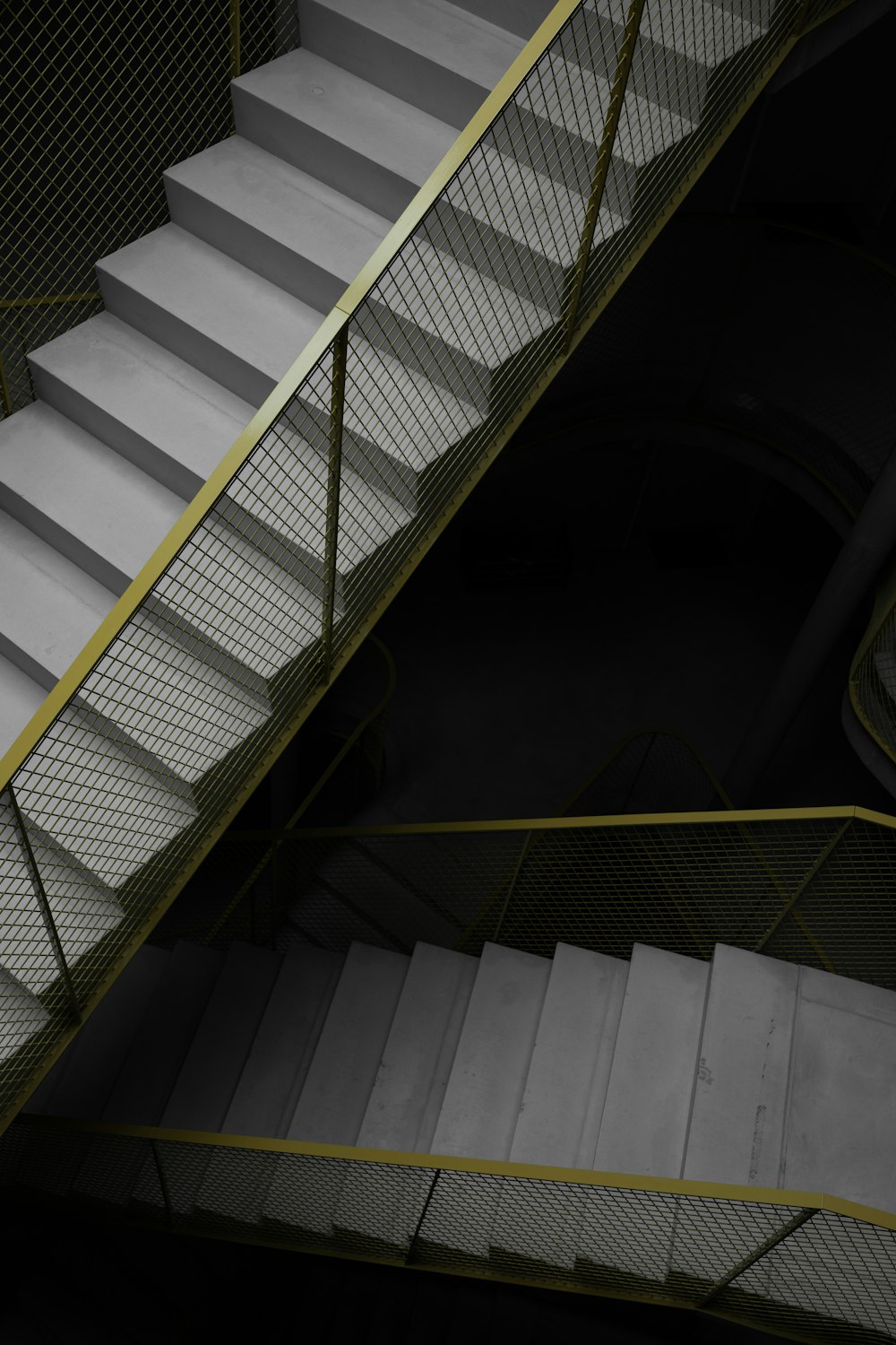 a staircase with a yellow hand rail and a yellow railing