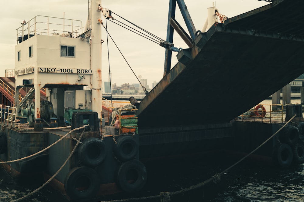 a large boat docked at a dock with a rope