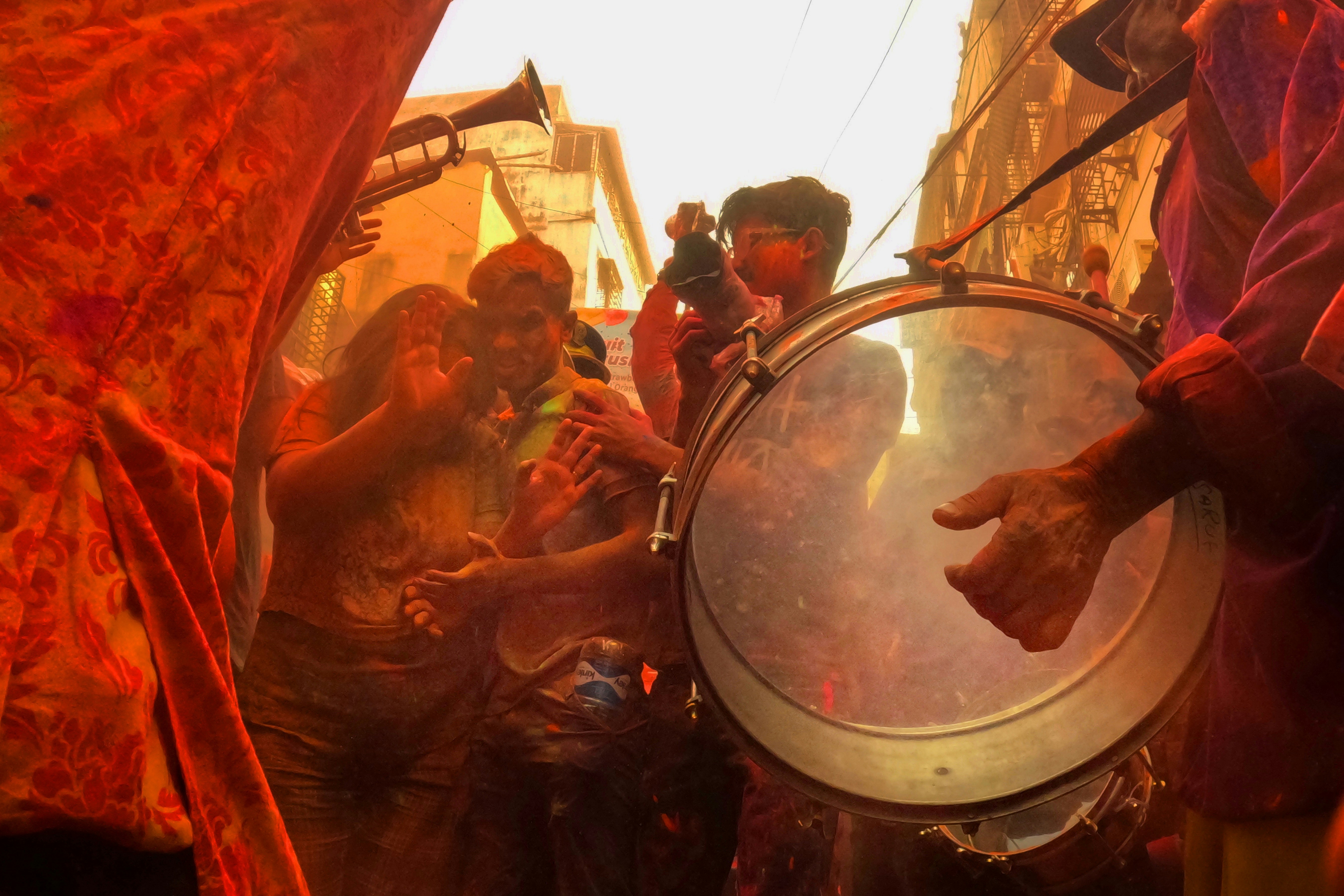 a group of people standing around a mirror