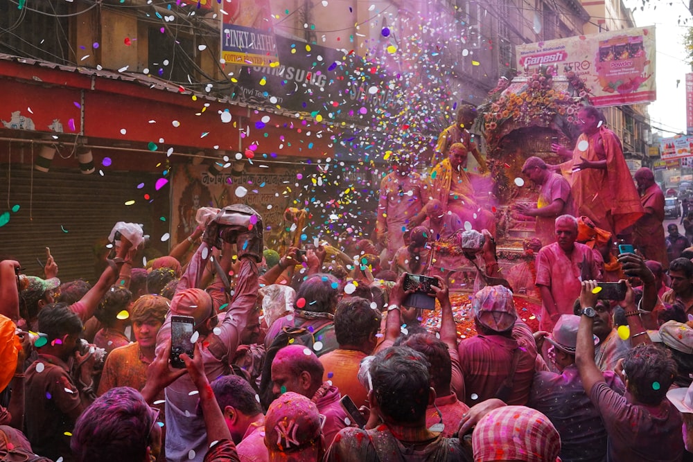 a group of people celebrating holi with colored powder