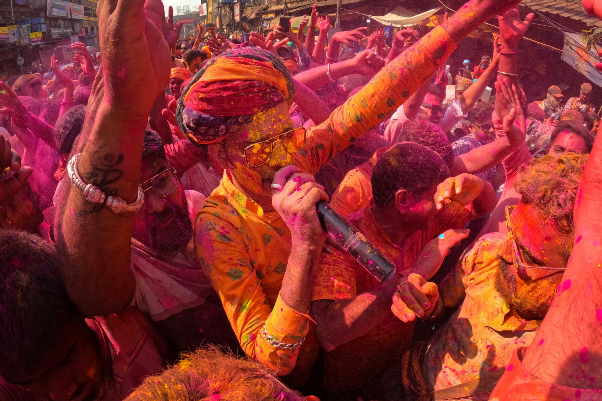 a group of people covered in colored powder