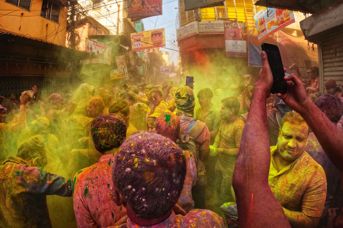 People playing Holi with coloured powder in an Indian street