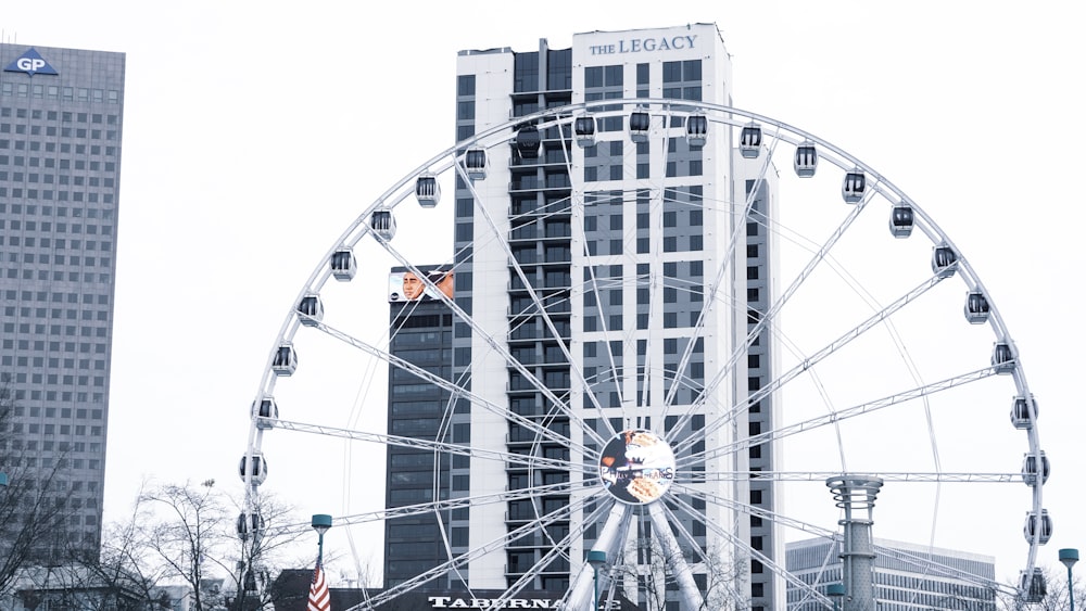 a ferris wheel in front of a tall building