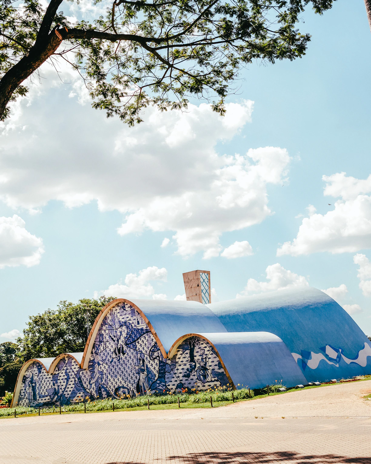 a blue and white building sitting under a tree