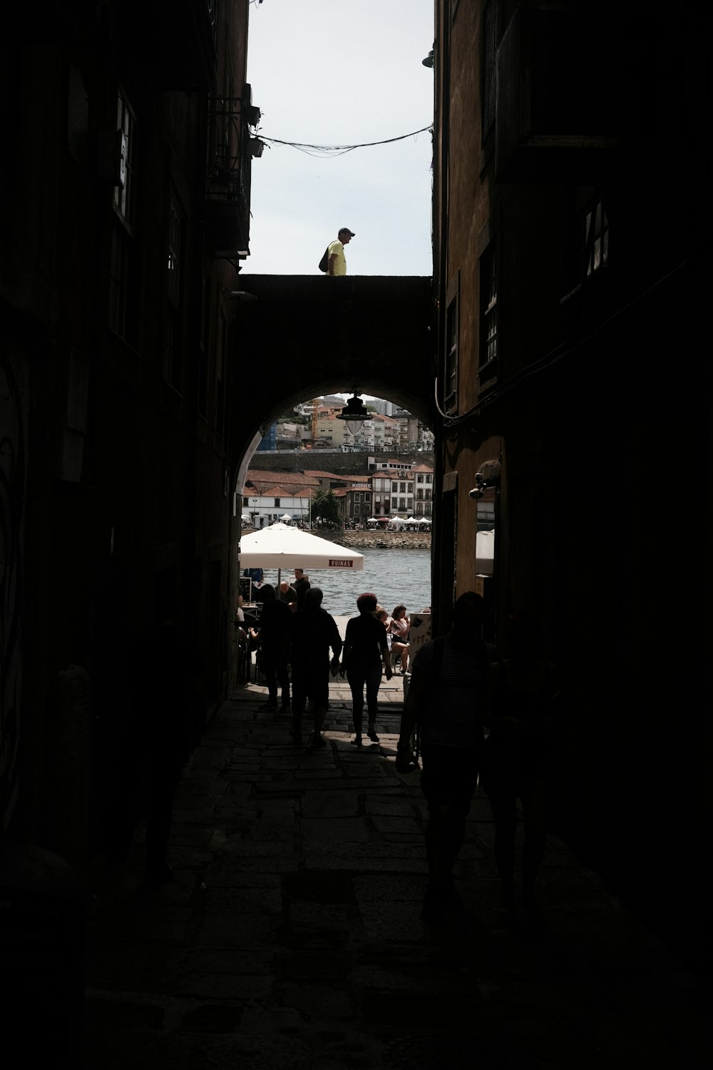 a group of people walking down a dark alley way