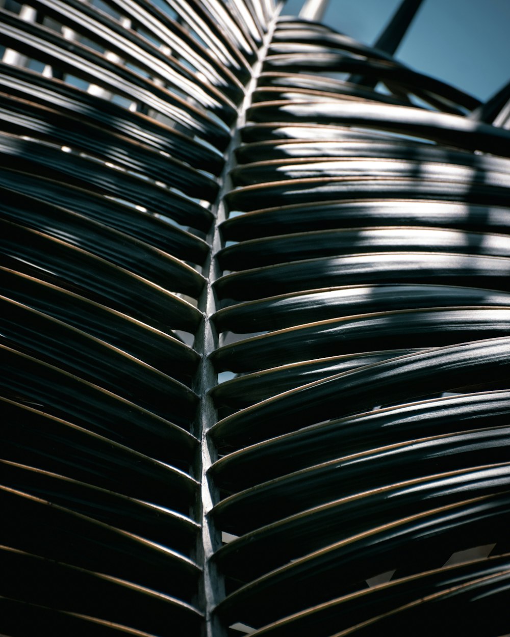 a close up of a metal structure with a blue sky in the background