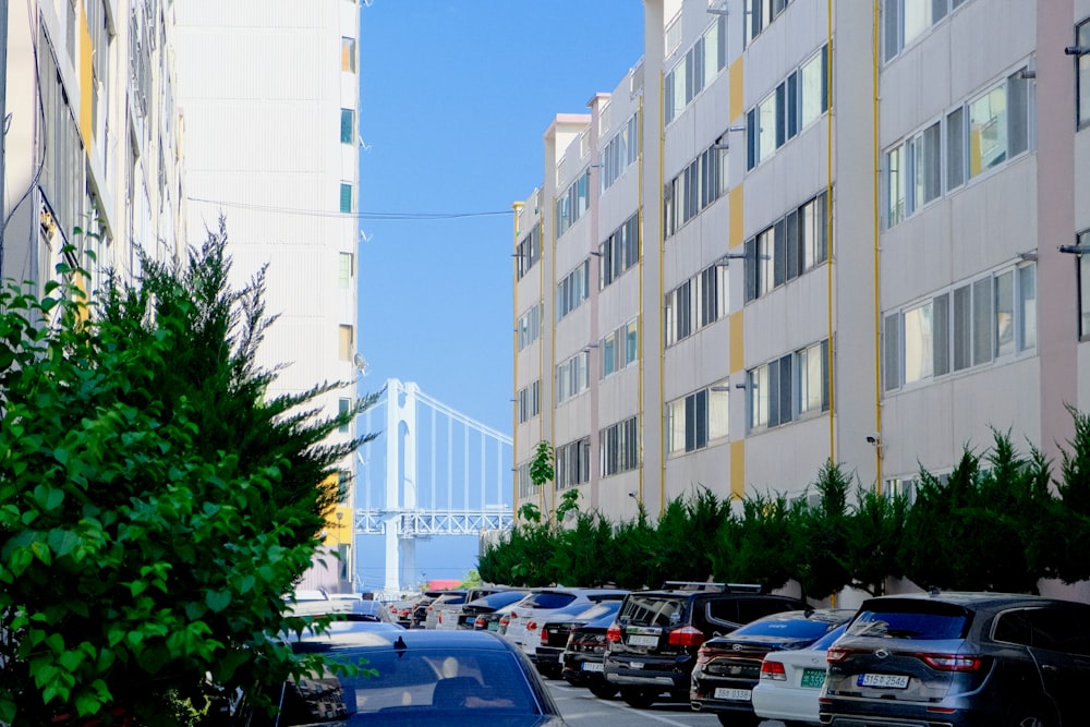 a city street filled with lots of traffic next to tall buildings