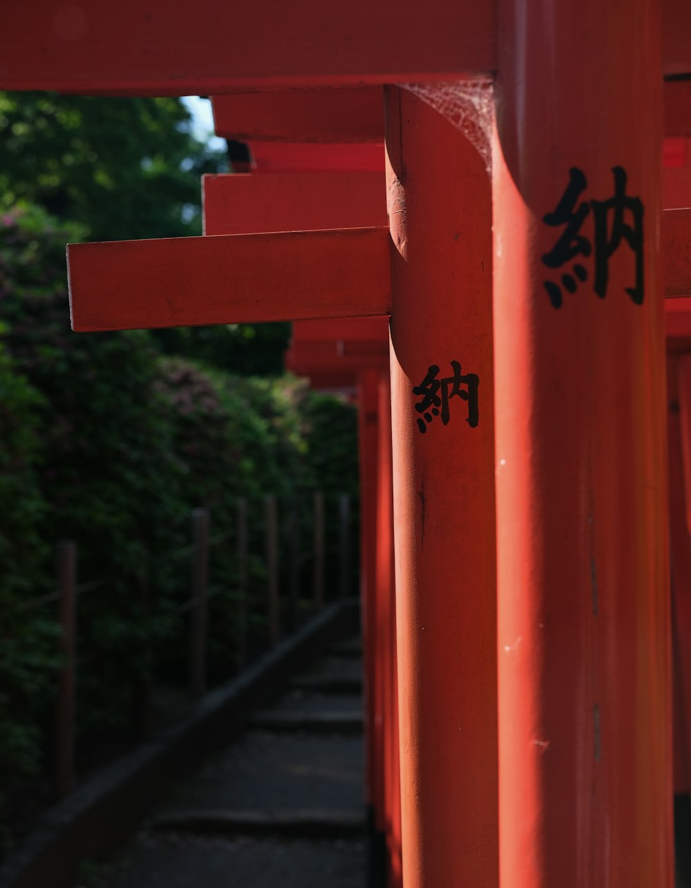 a row of red pillars with writing on them