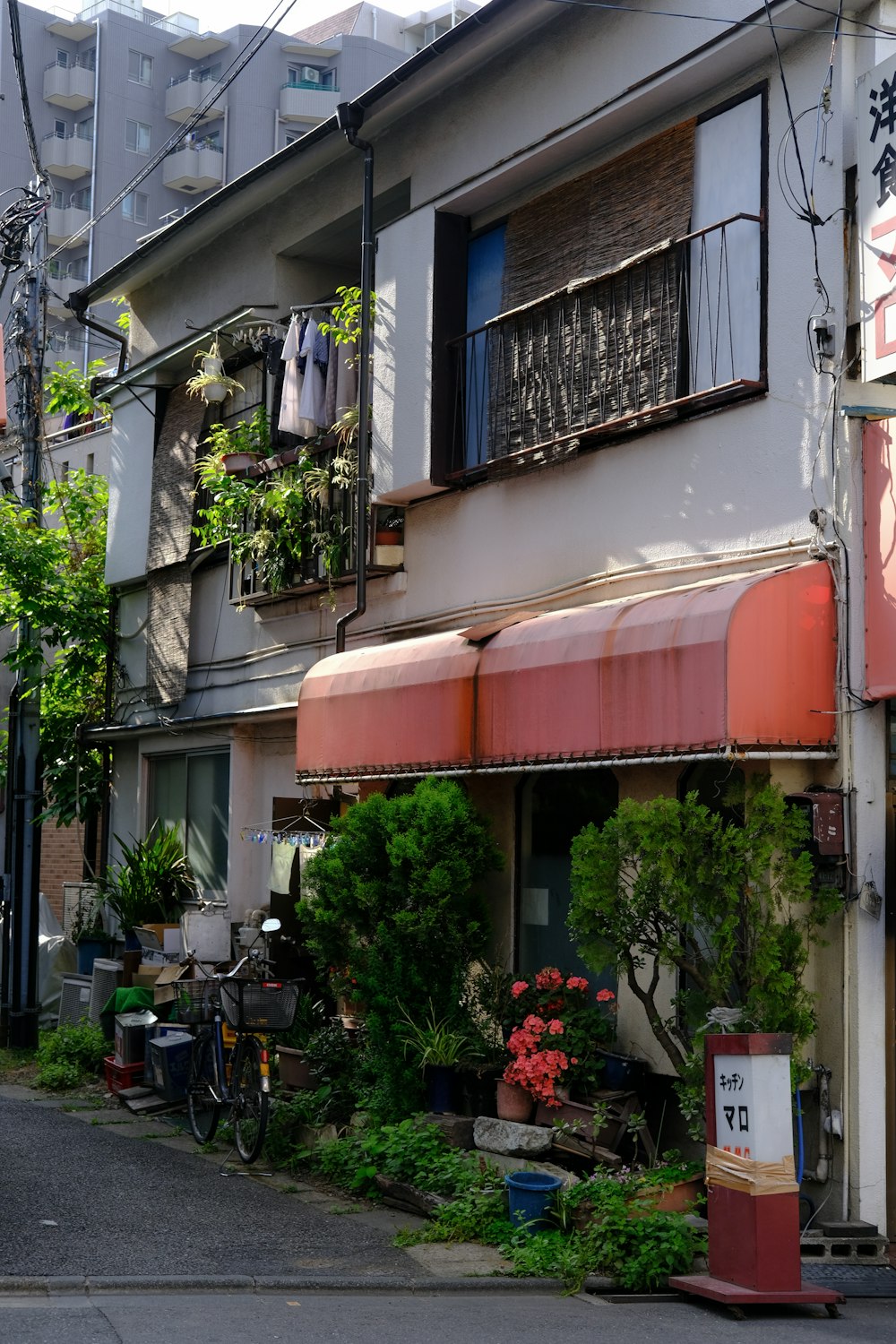 a building with a red awning next to a street