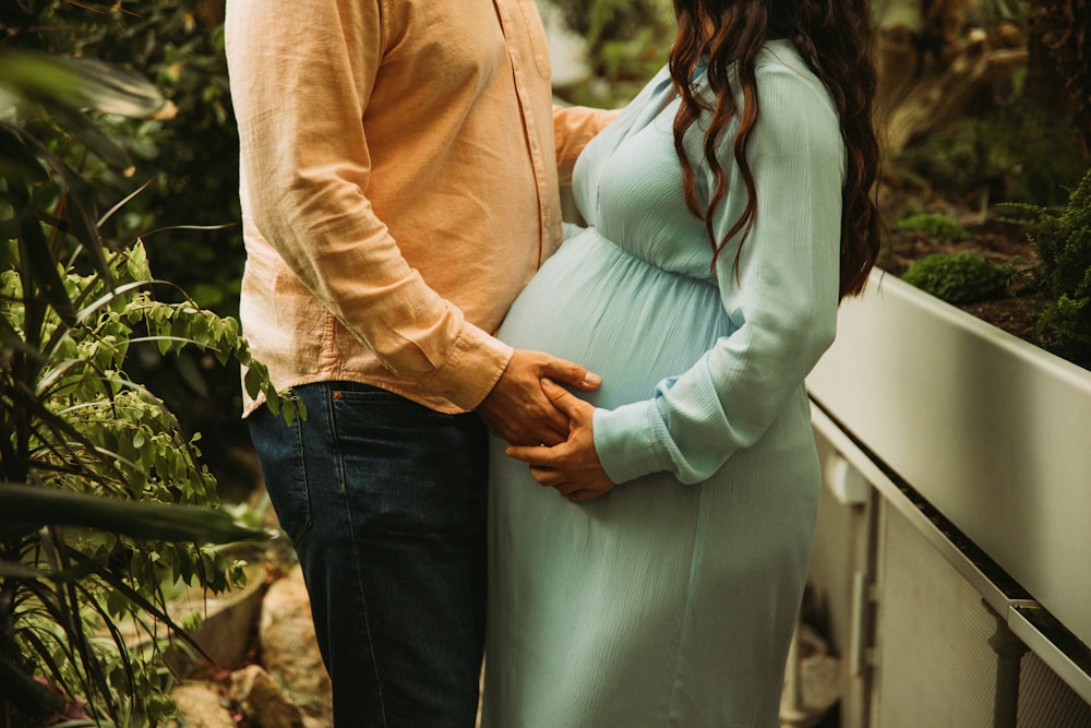 a pregnant couple standing next to each other