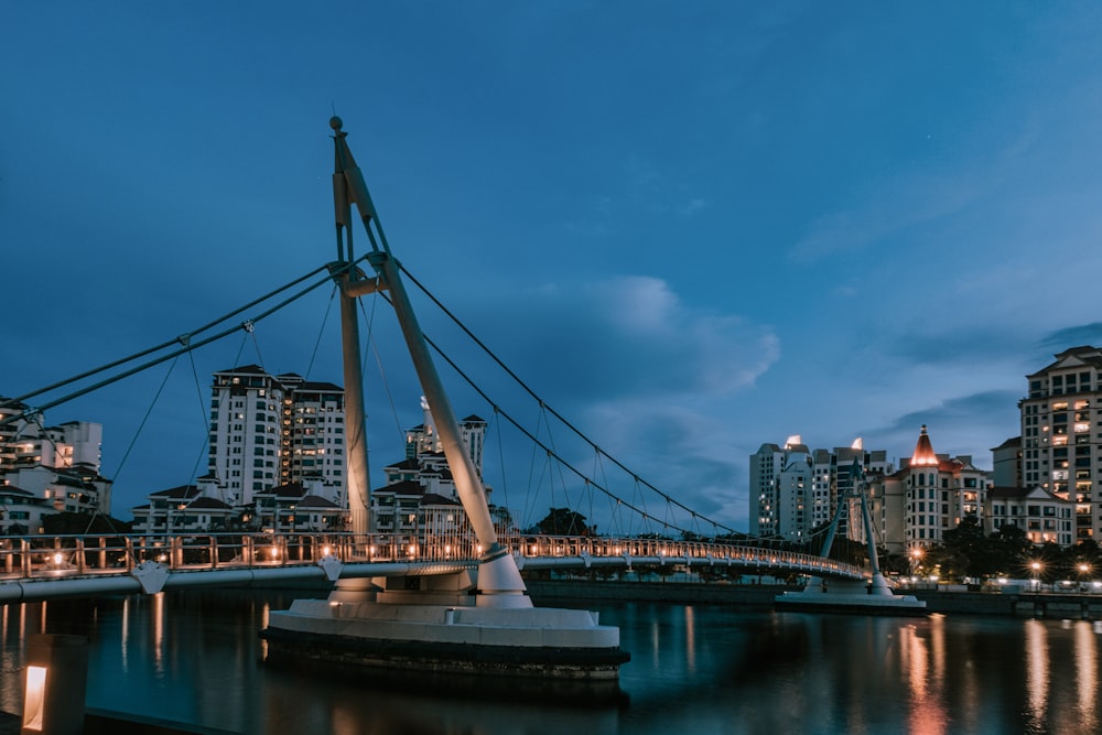 a bridge over a body of water with buildings in the background