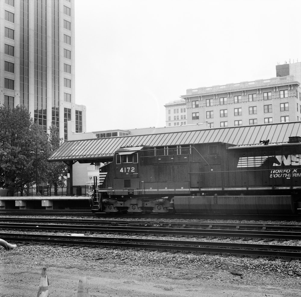 a black and white photo of a train on the tracks