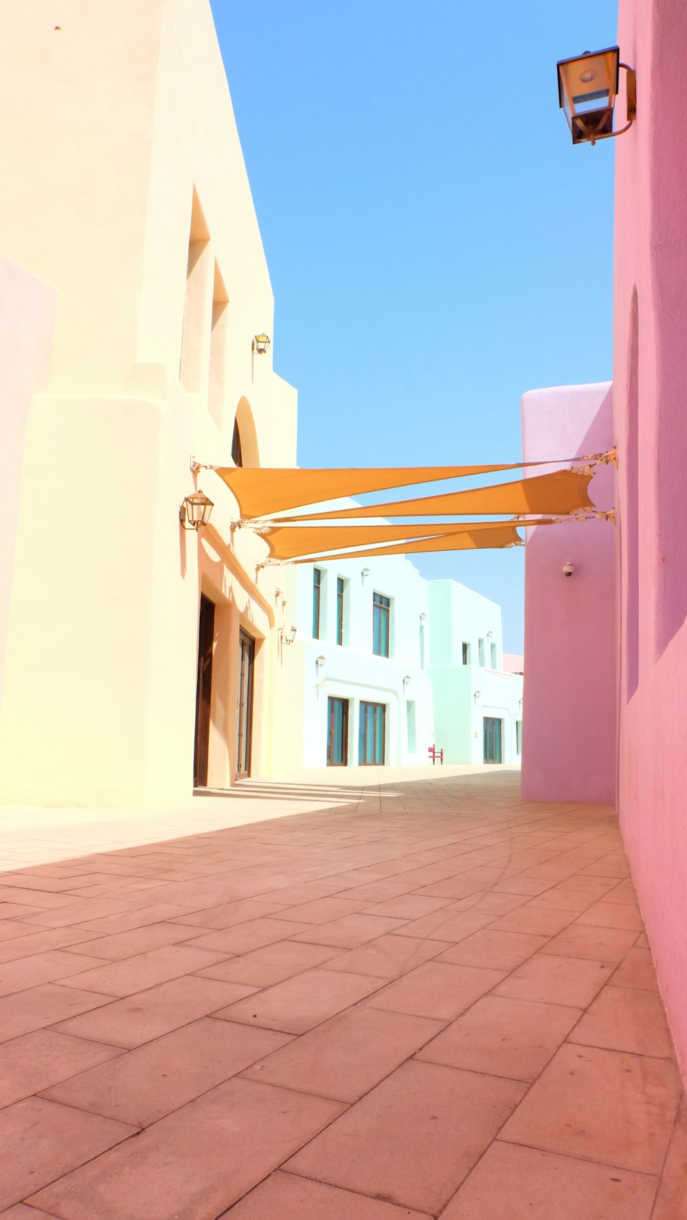 a pink building with a yellow awning next to it
