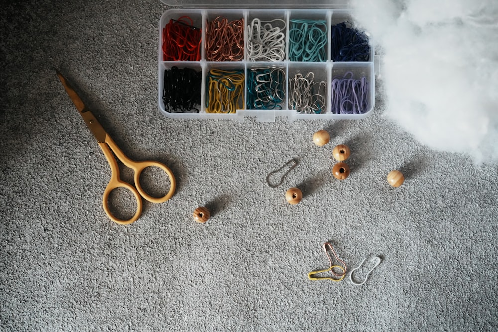 a plastic container filled with lots of crafting supplies