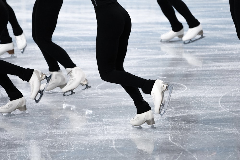 a group of people skating on an ice rink