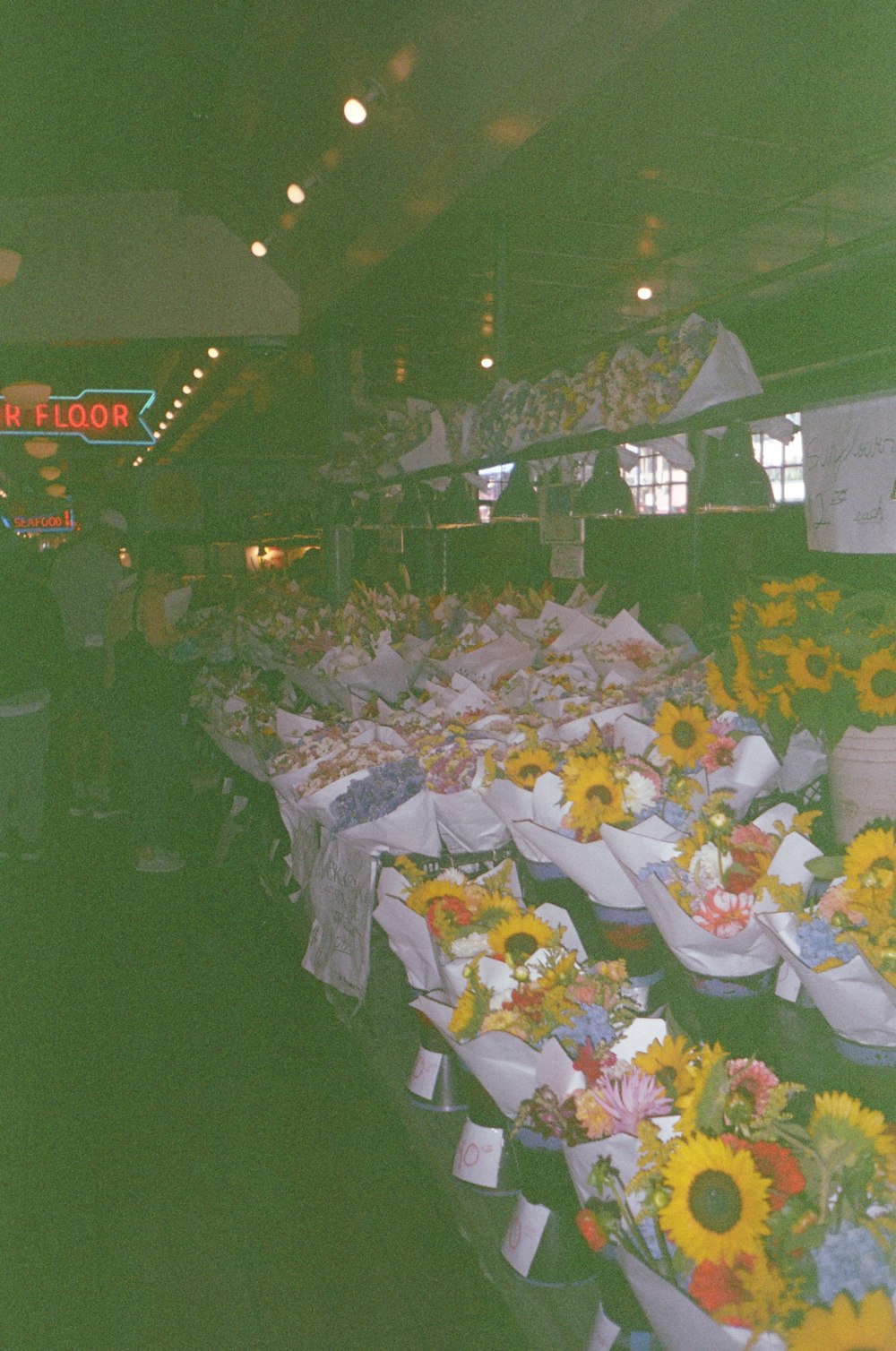 a bunch of sunflowers are on display in a store